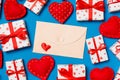 Top view of colorful valentine background made of craft envelope, gift boxes and red textile hearts. Valentine\'s Day concept Royalty Free Stock Photo
