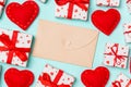 Top view of colorful valentine background made of craft envelope, gift boxes and red textile hearts. Valentine\'s Day concept Royalty Free Stock Photo