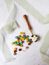 a top view of colorful wax bead and sealing wax with green silk ribbon on an old grey surface Royalty Free Stock Photo