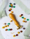 a top view of colorful wax bead and sealing wax with green silk ribbon on an old grey surface Royalty Free Stock Photo