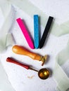 a top view of colorful wax bead and sealing wax with green silk ribbon on an old grey surface Royalty Free Stock Photo