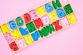 Top view of colorful wooden letters in their case, placed on a pink surface Royalty Free Stock Photo