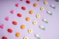 Top view - colourful medicine pills over pastel background