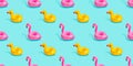Top view colourful pink flamingo,yellow duck toys vibrant colors seamless pattern on light pastel blue background. Flat lay illust