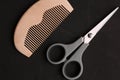 Top view of comb and scissors isolated on a black background - hairdressing concept Royalty Free Stock Photo