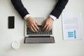 Top view of company CEO typing at laptop