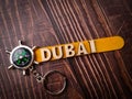 Top view compass and wooden word with text DUBAI