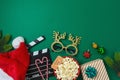 Top view composition for Christmas movie night and party concept with popcorn, Santa hat, decorations and movie clapper board on