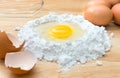 Top view composition flour with egg and ingredients for homemade bakery on wooden background Royalty Free Stock Photo