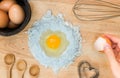 Top view composition flour with egg and ingredients for homemade bakery on wooden background