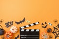 Top view composition for horror movie night and Halloween party with pumpkin, decorations and movie clapper board on orange Royalty Free Stock Photo