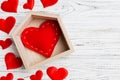 Top view composition made of red heart in a house surrounded with small hearts on wooden background. Home sweet home concept. Royalty Free Stock Photo