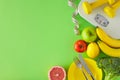 Top view composition made of scales, dumbbells and tape measure, plate with cutlery, vegetables and fruits Royalty Free Stock Photo