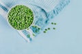 Top view composition with organic frozen vegetables on a light blue background. Green peas in a bowl Royalty Free Stock Photo