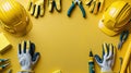 Top view composition of construction tools and safety gear arranged on a yellow background emphasizing the building and repair Royalty Free Stock Photo