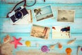 Top view composition - Summer photo album with starfish, shells, coral and items on wooden table.