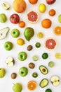 Top view of composition of various colorful fresh summer fruits scattered isolated over white background