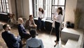 Concentrated different generations mixed race employees listening to skilled speaker. Royalty Free Stock Photo