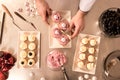 top view of confectioner arranging cupcakes