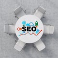 Top View of a conference room. A white round table and six white chairs around. Colourful SEO flowchart is drawn on the table surf Royalty Free Stock Photo