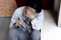 Top view of confused stressed Asian business man close his eyes and covering face with hands. Royalty Free Stock Photo