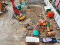 Top view of construction site with car, crawler pile driver, excavator and worker after raining day.