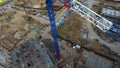 Top view of construction site with crane. Scene. Crane stands above roofs of buildings on construction site with