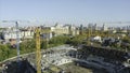 Top view of construction of sports arena with cranes. Stock footage. Construction of sports arena in center of modern