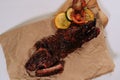 Top view of cooked ribs on a butcher paper on a white background