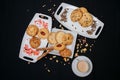 Top view of cookies on white plates with a cup of coffee on a black background Royalty Free Stock Photo