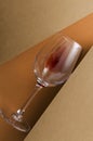 Top view of glass of red wine on the brown and orange colored surface.Vertical image.Concept of wine tasting