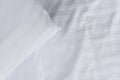top view corner of white pillow on white clean bed close up, Royalty Free Stock Photo
