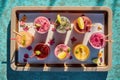 top view of cosmopolitan cocktails on poolside tray