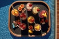 top view of cosmopolitan cocktails on poolside tray