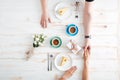 Top view of couple eating cakes and holding hands Royalty Free Stock Photo