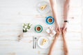 Top view of couple holding hands and drinking coffee Royalty Free Stock Photo