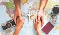 Top view of couple planning their vacation with world map - Lovers getting ready for the next world tour Royalty Free Stock Photo