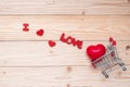 Top view couple red heart shape with mini shopping cart on wooden table. love, shopping and Valentine Day Royalty Free Stock Photo