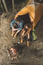 top view of couple roasting marshmallow on sticks