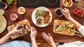 Top view of couple of vegetarians preparing various healthy toasts in the kitchen together. Man getting out sun dried Royalty Free Stock Photo