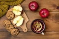 Top View of Cozy Autumn Morning at Home Breakfast With Cup of Hot Berries Tea Red Apples Cookies Yellow Woolen Scarf Wooden Backgr