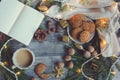 Top view of cozy Christmas and winter setting with homemade cookies, coffee, nuts, weekly planner and New Year decorations