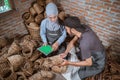 top view of craftswoman and craftsman using tablet among crafts