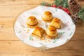Top view of cream cakes with biscuit on plate and wooden table with Christmas decorations, Royalty Free Stock Photo