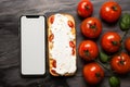 Top view cream cheese and tomato sandwich beneath a blank phone creative pairing