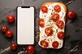 Top view cream cheese and tomato sandwich beneath a blank phone creative pairing