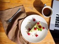 Top view of a creamy cupcake with cofee on the wooden table. Food concept.