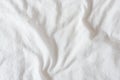 Top view of creased / wrinkles on a white unmade / messy bed sheet. Royalty Free Stock Photo