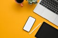 Top view of a creative office desk workspace with smartphone mockup on yellow background Royalty Free Stock Photo