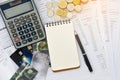 Top view of credit cards with statements, pen, blank notepad, stack of coins and calculator on white background, financial concept Royalty Free Stock Photo